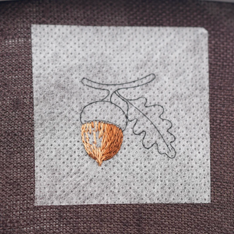 Outline the left side of the acorn with split stitch, then fill the remaining area with long and short stitch, blending DMC 436 into the previous shades.