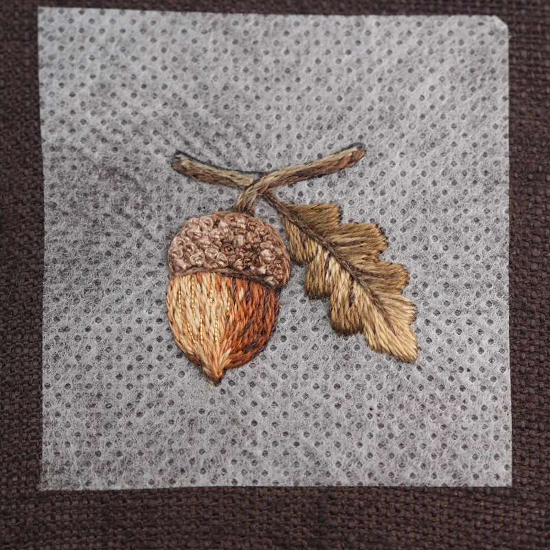 Add a few stitches of gold metallic thread to the lighter left side of the acorn to create a subtle shimmer.