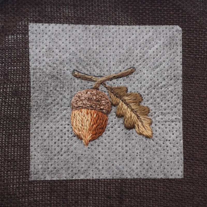 Fill the upper part of the branch with DMC 3032 using split stitch.