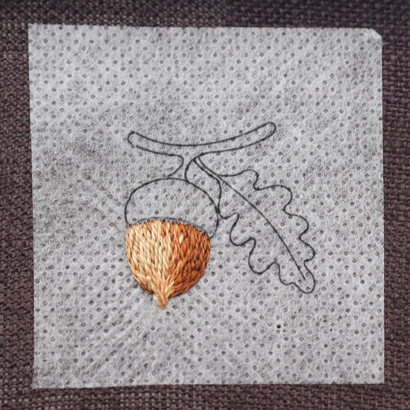 Fill the remaining area of the acorn with DMC 422, blending it into the previous shades with long and short stitches to create smooth, natural transitions.