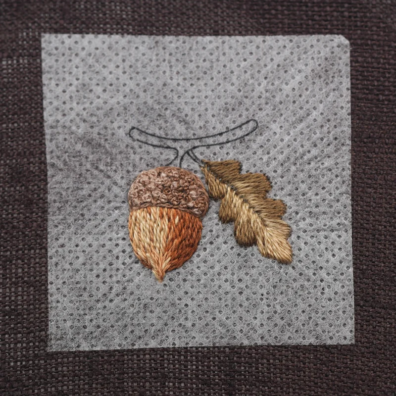 Fill the remaining areas with DMC 610, blending it into the previous shades to create smooth transitions. Along the outer edge of the leaf, extend all stitches slightly beyond the split-stitch outline to create a clean, natural edge.