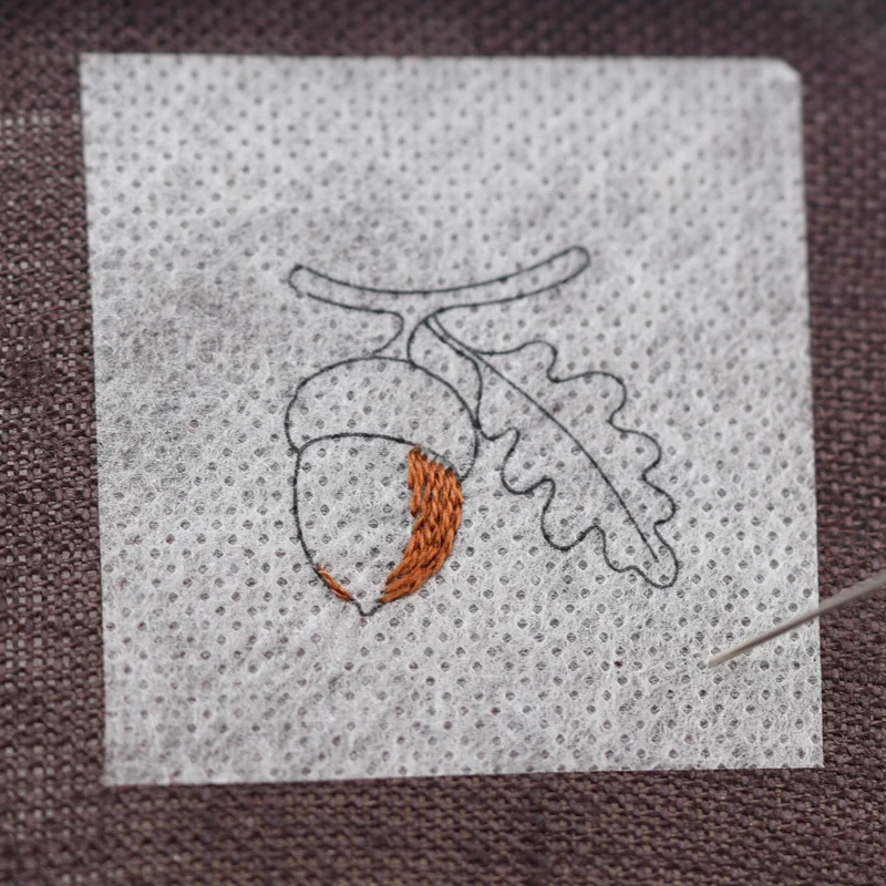 Outline the right side of the acorn with split stitch, then fill the area with long and short stitch, following the shape of the acorn.